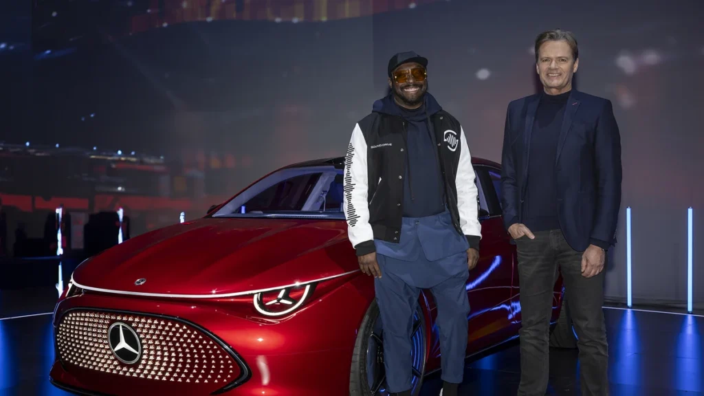 will.i.am and a friend with a red Mercedes-Benz